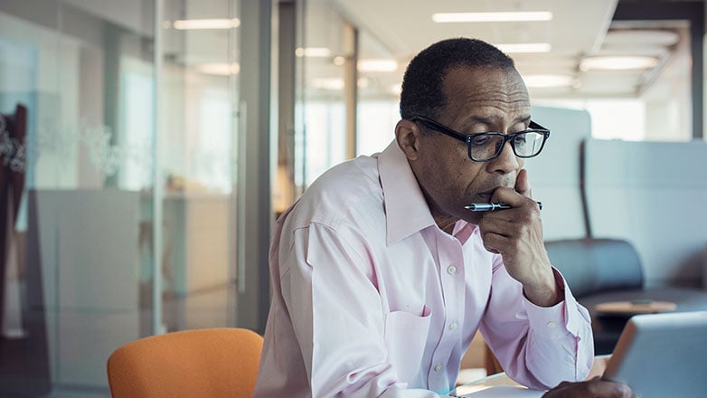 Man working on his tablet in his office.